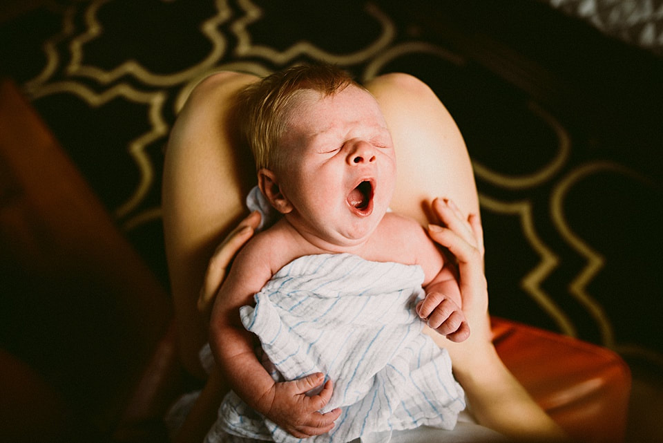 Newborn baby yawns during an at-home photography session near Charlottesville, Virginia