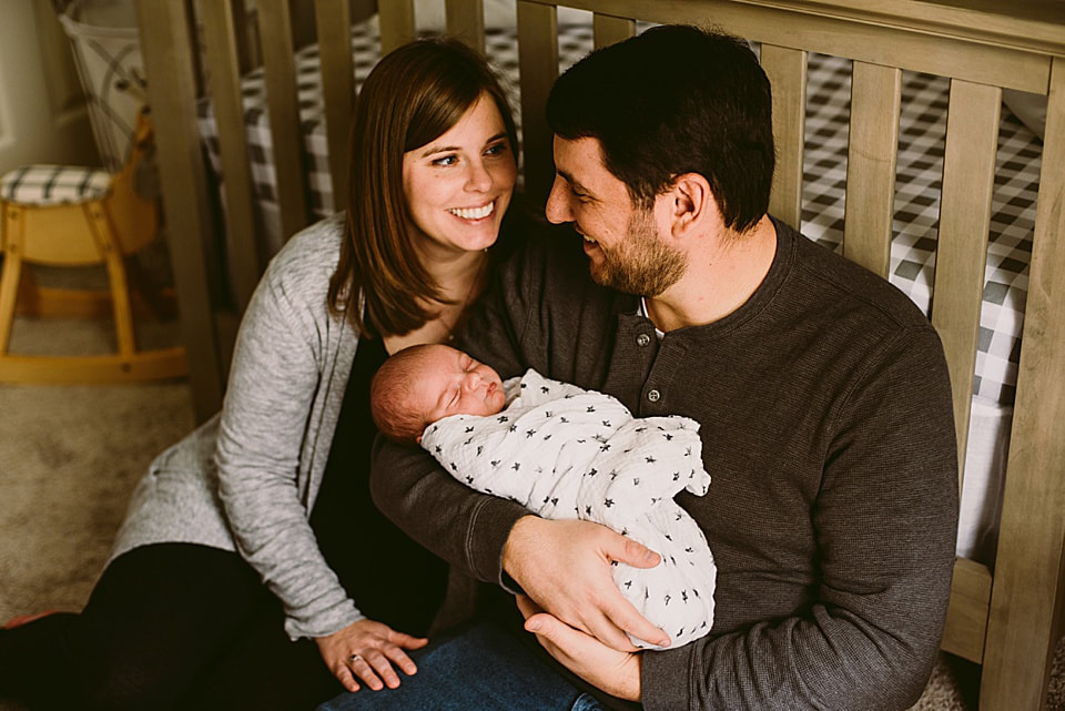 First-time parents during their at-home newborn photography session