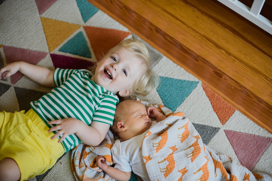Siblings during an at-home newborn session in Roanoke Virginia by Laura Richards Photography