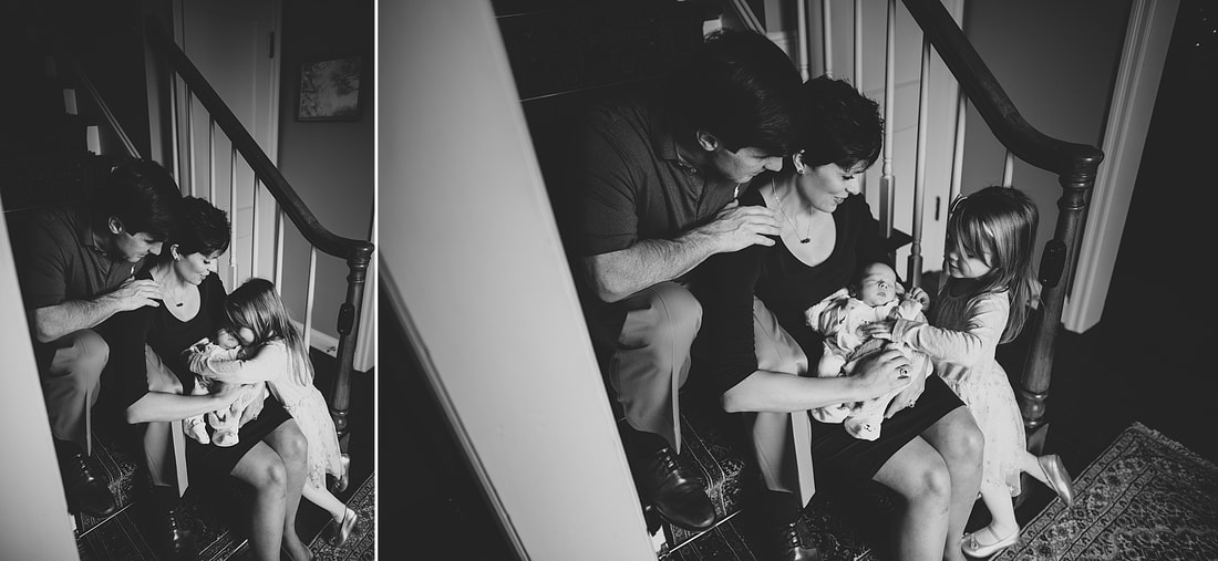 family cuddled on the stairs with their baby boy