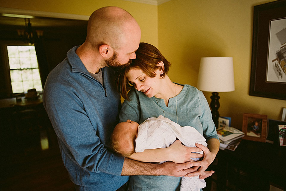 Mom, dad and newborn baby during an at-home session - Charlottesville Newborn Photographer